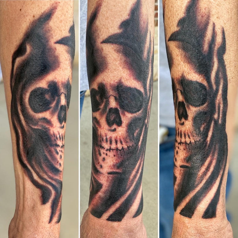 Skull half sleeve tattoo on lower forearm by Nick Young
